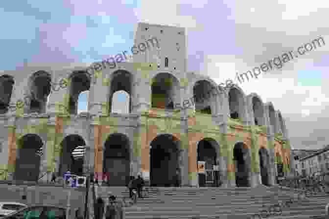 A Stunning Image Of The Roman Amphitheater In Arles, France, With Its Imposing Arches And Towering Tiers Of Seating. The Roman Remains Of Northern And Eastern France: A Guidebook